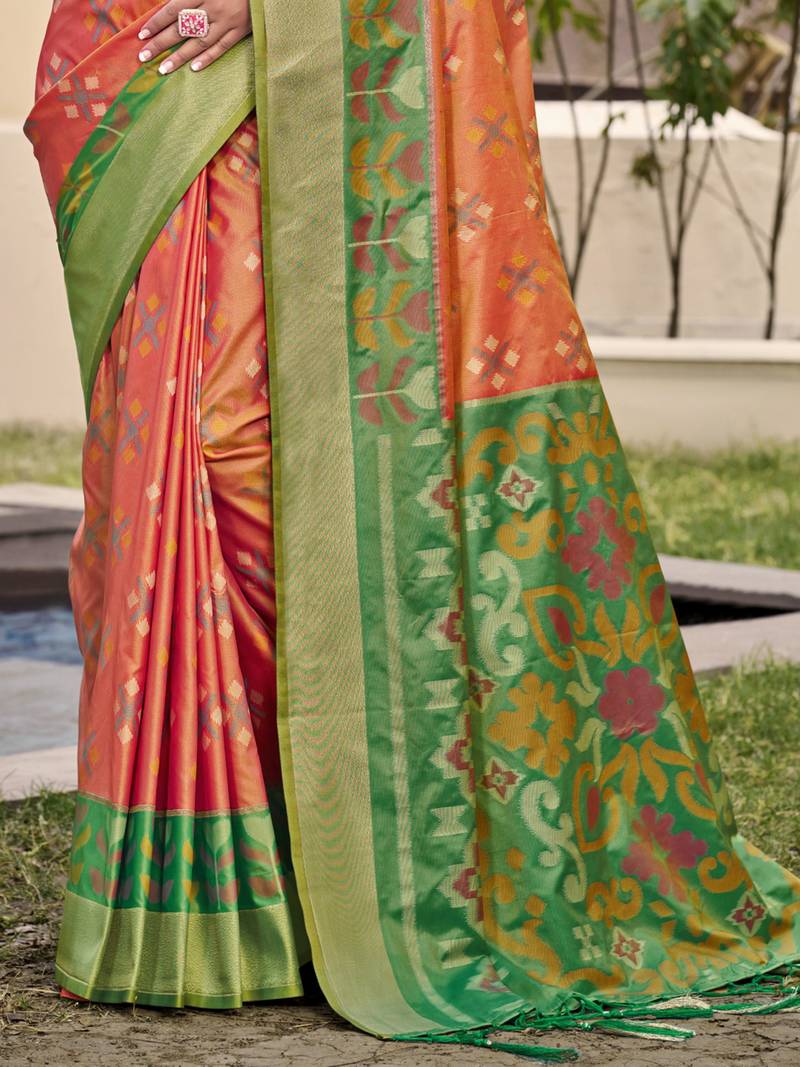 Vibrant orange and green patola-inspired silk blend saree