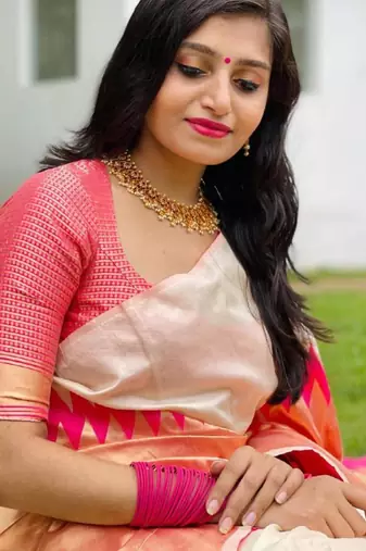 Cream off-white silk blend saree with striking pink and orange border