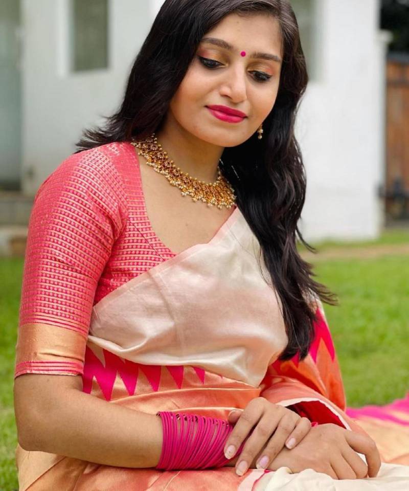 Cream off-white silk blend saree with striking pink and orange border