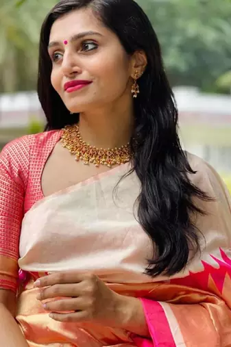Cream off-white silk blend saree with striking pink and orange border