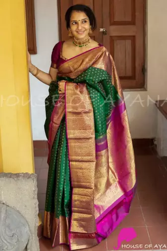 Emerald green silk blend saree with magenta and gold ornate border