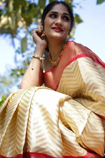 Elegant cream chevron silk blend saree with red border