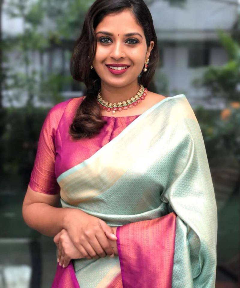 Mint green silk blend saree with vibrant magenta border