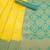 Radiant yellow silk blend saree with ornate teal border