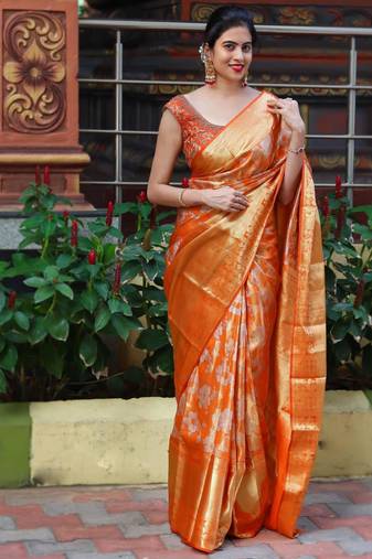 Radiant orange silk blend saree with exquisite gold brocade weave