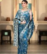 Teal blue silk blend saree with silver floral vines