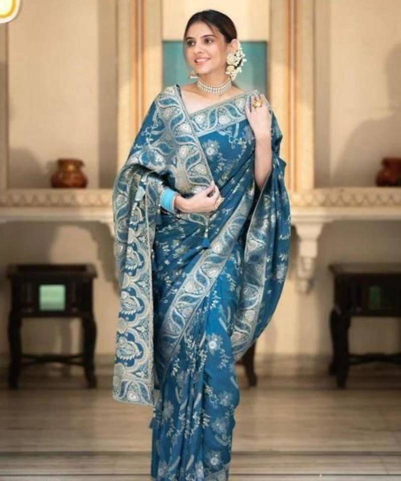 Teal blue silk blend saree with silver floral vines