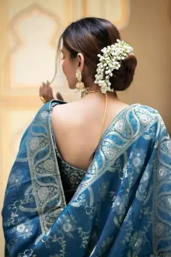 Teal blue silk blend saree with silver floral vines