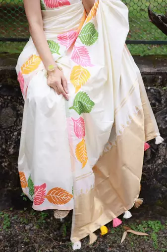 Off-white silk blend saree with colorful leaf motifs