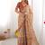 Beige handloom cotton saree with rust blouse and village celebration print