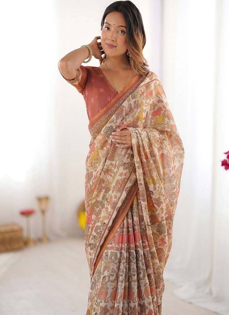 Beige handloom cotton saree with rust blouse and village celebration print