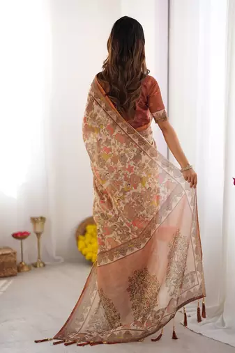Beige handloom cotton saree with rust blouse and village celebration print
