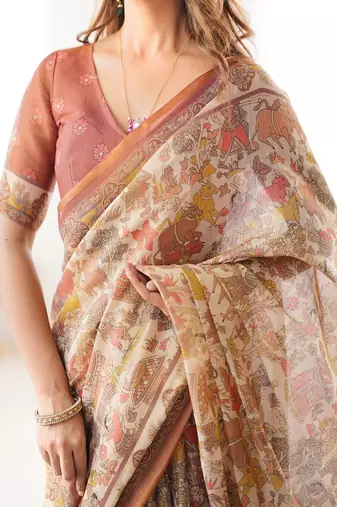 Beige handloom cotton saree with rust blouse and village celebration print