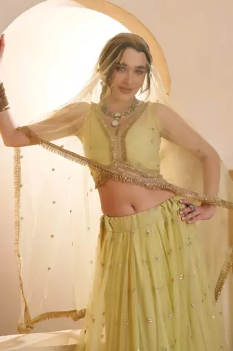 Sparkling Yellow Thread Embroidered Net Engagement Wear Lehenga Choli