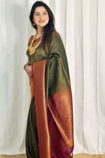 embellished dark green self design silk cotton saree with unstitched blouse