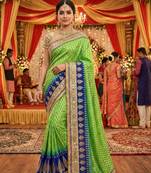 viscose silk wedding wear saree in green with crystals stone work