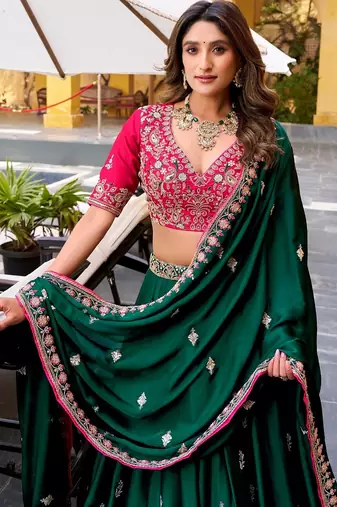dark-green lehenga with pink embroidered blouse