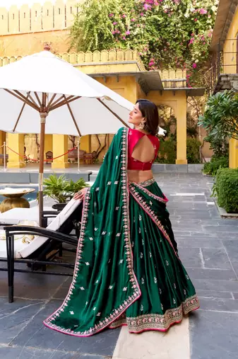 dark-green lehenga with pink embroidered blouse