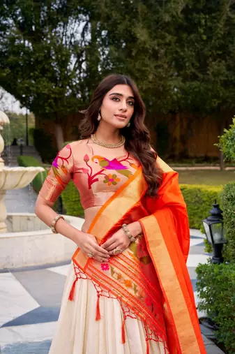 off-white lehenga with orange dupatta