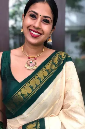 Traditional cream green border silk blend saree