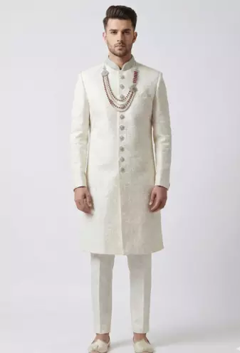 Pristine white handcrafted intricate thread work raw silk wedding sherwani with embellished mandarin collar