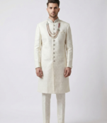 Pristine white handcrafted intricate thread work raw silk wedding sherwani with embellished mandarin collar