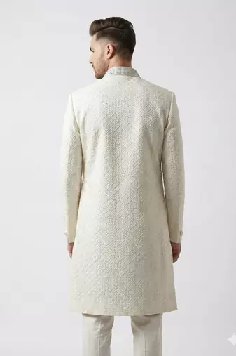 Pristine white handcrafted intricate thread work raw silk wedding sherwani with embellished mandarin collar