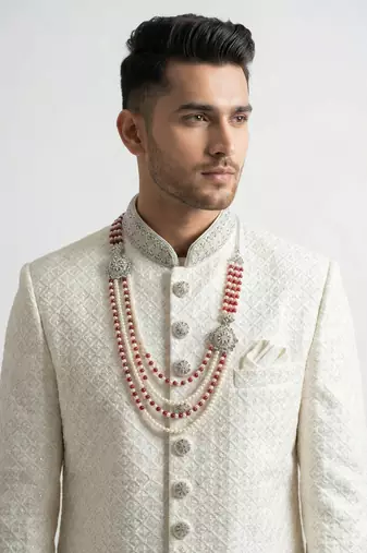 Pristine white handcrafted intricate thread work raw silk wedding sherwani with embellished mandarin collar