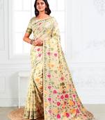 cream linen saree with multicolor woven leaf patterns