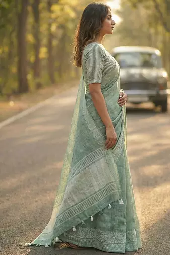 women teal green & silver-toned woven design linen blend saree