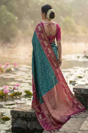 women teal blue soft silk blend saree with pink nandi zari border