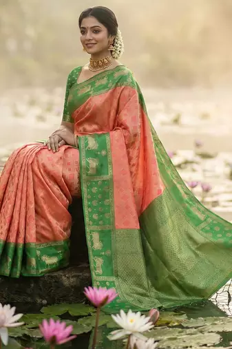 women peach soft silk blend saree with green nandi zari border