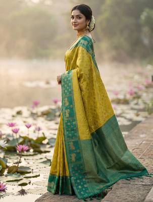 women yellow soft silk blend saree with green nandi zari border 3