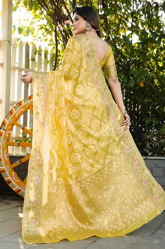 yellow organza silk saree with floral woven border