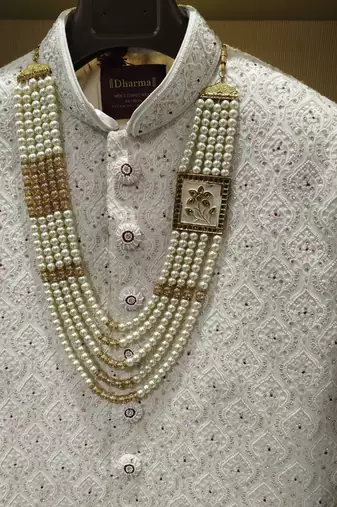 white silk sherwani with detailed hand embroidery