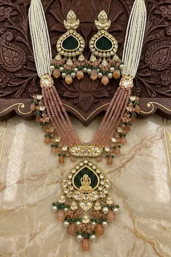 gold brass necklace set with lakshmi pendant peach bead motifs