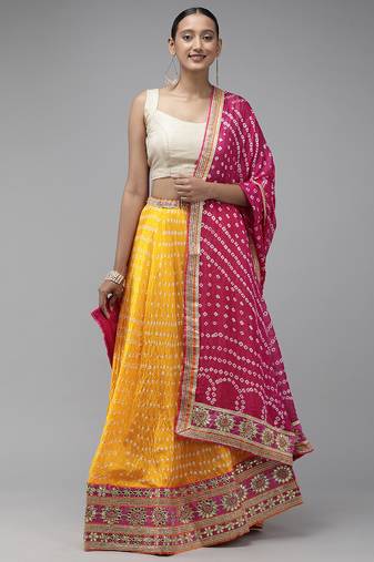 yellow silk patchwork lehenga set with pink bandhani dupatta