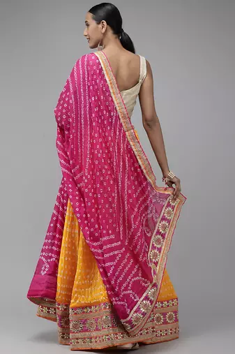 yellow silk patchwork lehenga set with pink bandhani dupatta
