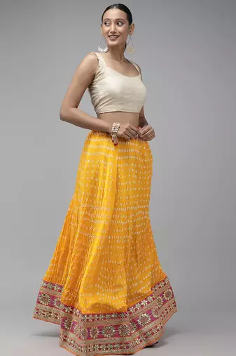 yellow silk patchwork lehenga set with pink bandhani dupatta