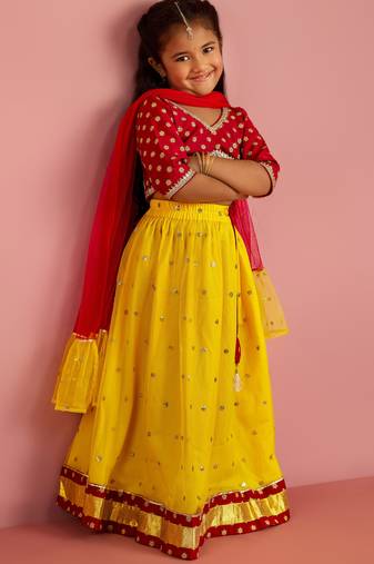 girls yellow net lehenga choli with sequin work