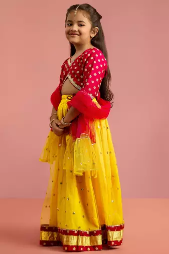 girls yellow net lehenga choli with sequin work