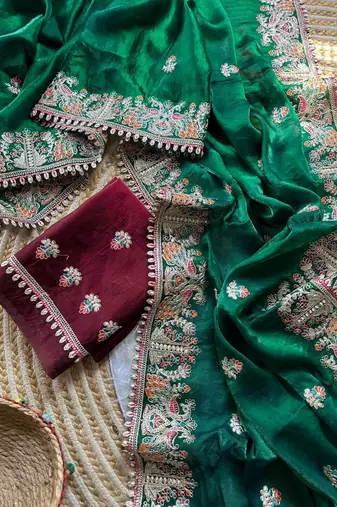 green satin silk saree with floral embroidery and tassels