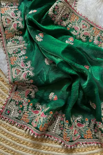 green satin silk saree with floral embroidery and tassels