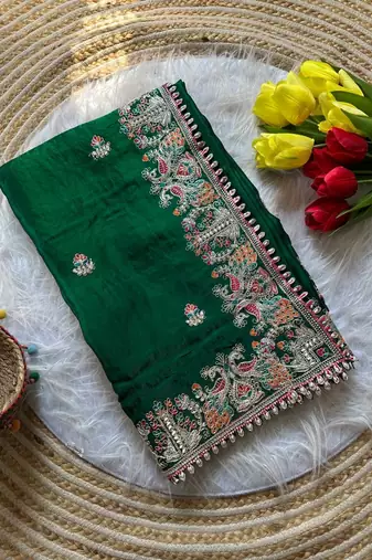 green satin silk saree with floral embroidery and tassels