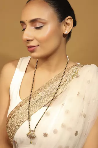 gold tone long mangalsutra with black beads & oval pendant