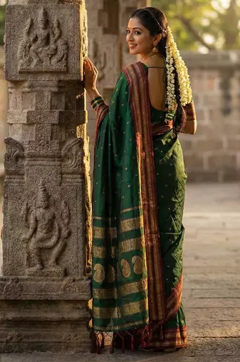 Dark green silk woven saree with blouse