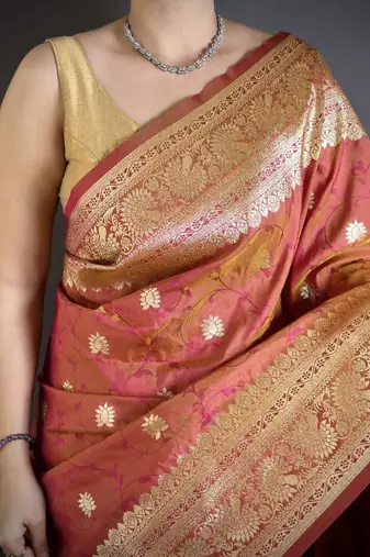 Peach color zari woven banarasi silk blend saree with blouse