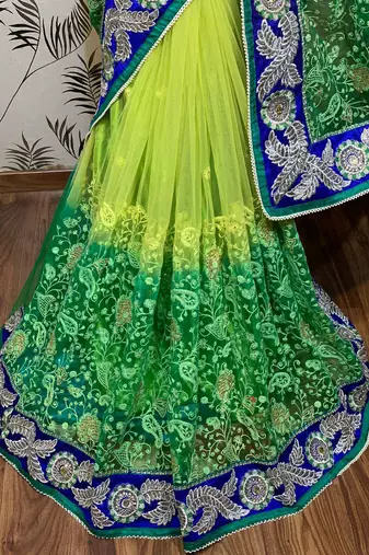 Soft premium net party wear saree in green with embroidery work & crystal stone work