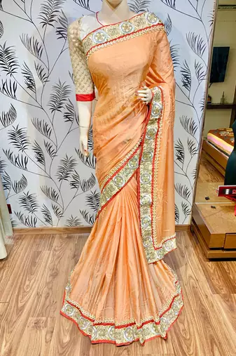Fancy fabric party wear saree in peach with embroidery work & crystal stone work