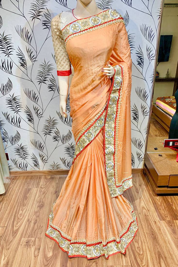 Fancy fabric party wear saree in peach with embroidery work & crystal stone work